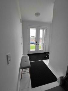 a room with a hallway with a bench and a door at Brand New 4 bedroom Villa by Hamilton Airport! in Hamilton