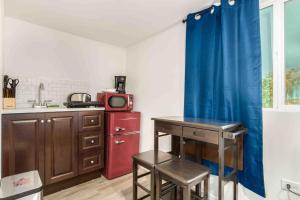 a kitchen with a table and a blue curtain at Your Downtown Cozy Studio With Backyard Unit C in Phoenix