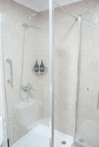 a bathroom with a shower with a glass door at VV - La Plazuela in Arrecife