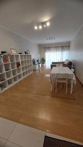 a living room with a table and a couch at Paim Maria in Ponta Delgada