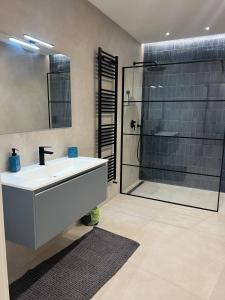 a bathroom with a sink and a glass shower at Casa Vostra in Taranto +17 photos