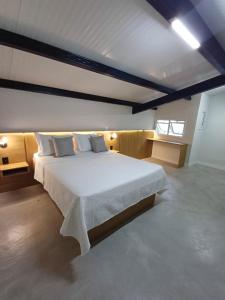 a bedroom with a large bed and a window at LOFTS GREEN ISLAND in Angra dos Reis