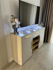 a bathroom counter with a sink with lights on it at President Lux Apartment in Pale
