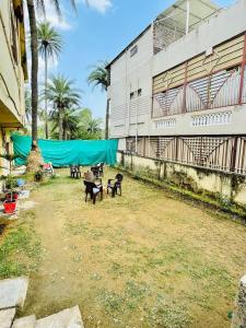 a group of benches in front of a building at Naivedyam villa in Mount Ābu