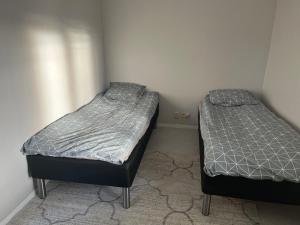 two twin beds in a room with at LHM in Borås