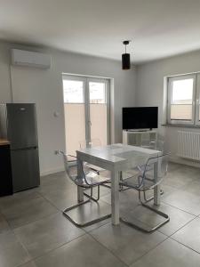 a white table and chairs in a living room at Apartament Jana Pawła in Nowy Sącz
