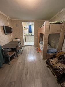 a room with a table and bunk beds and a dining room at Babulya House in Gyumri