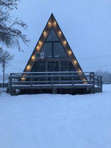 a building with lights on it in the snow at Soul House in Pilipets