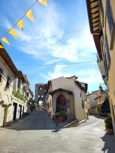 eine Gasse mit einem Gebäude und Flaggen auf einer Straße in der Unterkunft La Casa di Nella in Lastra a Signa
