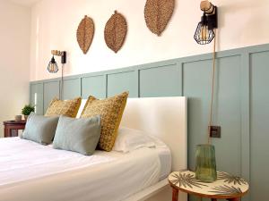 um quarto com uma cama branca e duas mesas em Meloneras by the sea em San Bartolomé