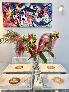 a table with a vase with flowers on it at Luxury Apartment in the center in Edessa