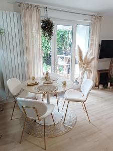 a living room with a table and chairs and a fireplace at Appartement REZ DE JARDIN avec SPA entre la MER et Montpellier 10mn in Lattes