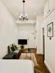 a living room with a bed and a tv at STYLISH 1Bhk HEART OF THE CITY in Edinburgh