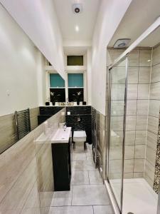 a bathroom with a shower and a sink and a toilet at STYLISH 1Bhk HEART OF THE CITY in Edinburgh