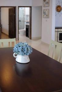 a vase with blue flowers sitting on a table at Tortugas Bay, MX in Don Pancho