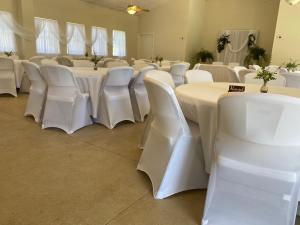 a room with white tables and white chairs at The Springs Retreat in Leakey