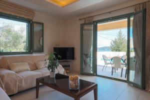 a living room with a couch and a table at Scorpios Villa in Kefallonia
