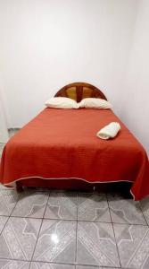 a bed with a red blanket on top of it at Casa Andrea. Crucecita Huatulco. in Santa Cruz Huatulco
