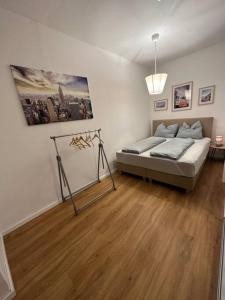 a bedroom with a bed and a wooden floor at Studio mit Terrasse im Zentrum in Gronau