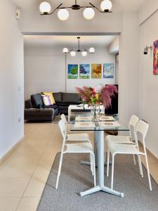 a dining room and living room with a table and chairs at Luxury Apartment in the center in Edessa