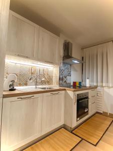 a kitchen with white cabinets and a sink at Ski paradise - Cielo alto Cervinia in Breuil-Cervinia