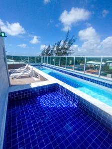 a swimming pool on top of a building at La Coruña Flat Makaranduba in Porto De Galinhas