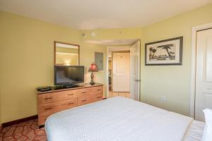 a bedroom with a bed and a television on a dresser at Bay View 1011, City View, 4ppl in Myrtle Beach