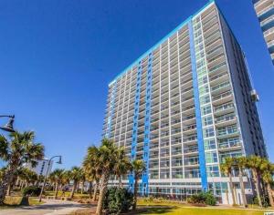 a large building with palm trees in front of it at Bay View 1011, City View, 4ppl in Myrtle Beach