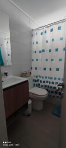 a bathroom with a tub and a toilet and a sink at Departamento nuevo y cómodo in Santiago