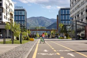 a young child riding a bike down a street at 4friendscoresibrasov M&L in Braşov