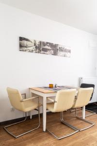 a table and two chairs in a room at Apartamenty u Jakubika in Krynica Zdrój
