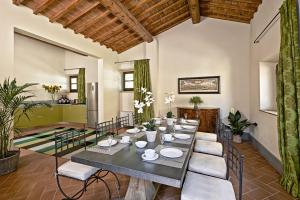 a dining room with a long table and chairs at Villa Medicea di Lilliano in Grassina