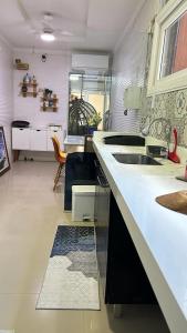 a kitchen with a sink and a counter top at Tropical Suítes-Próx Praça da República in Belém