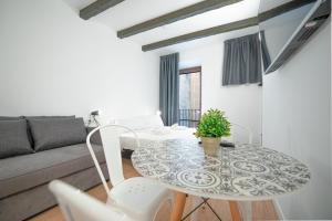 sala de estar con mesa y sofá en ESTUDIO ROMAN & CATHEDRAL EXPERIENCe, en Tarragona