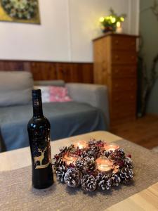eine Flasche Wein und Kerzen auf dem Tisch in der Unterkunft ChillHouse in Loučná nad Desnou
