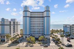 a large building with a parking lot in front of the ocean at Oceanfront 1BR, Downtown, 4ppl in Myrtle Beach