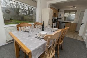 una mesa de comedor con un mantel blanco. en Dwellcome Home Ltd 3 Bedroom Boldon House - see our site for assurance, en Boldon