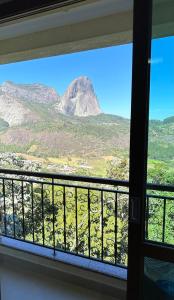 a view of a mountain from a window at Vista Azul Hotel in Domingos Martins