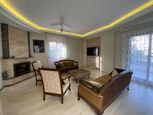 a living room with a couch and a fireplace at Comfortable villa with garden in “Urla İskele” in Urla