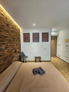 a bedroom with a bed and a brick wall at Arya Cagliari in Cagliari