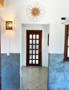 a hallway with a door and a chandelier at Santo Hostel in Porto Seguro
