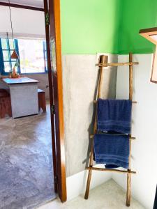 a chair sitting in a room next to a wall at Santo Hostel in Porto Seguro