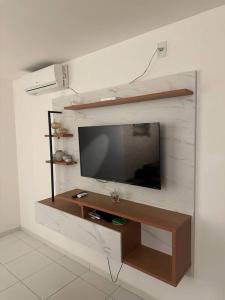 a flat screen tv hanging on a white wall at Apt Real in Paulo Afonso