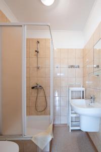 a bathroom with a shower and a sink at Rajska Mierzeja in Sarbinowo