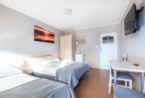 Ένα ή περισσότερα κρεβάτια σε δωμάτιο στο Rajska Mierzeja