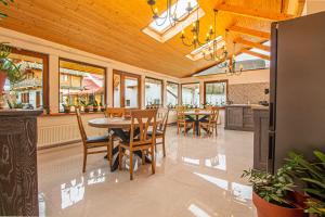 a dining room with tables and chairs and windows at RunCa-n Rai in Cristian