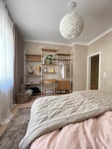 a bedroom with a large bed and a chandelier at Hygge-Apartment Jena in Jena