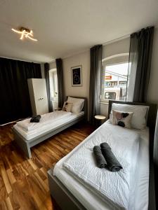 En eller flere senge i et værelse på OhPardon! GAILDORF - EG Wohnung, Terrasse, Einzelbetten
