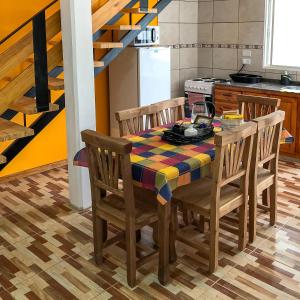 a kitchen with a dining room table and chairs at SOL Y SIERRAS in Mina Clavero