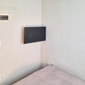 a bedroom with a bed with a television on the wall at King's Garden in Seoul